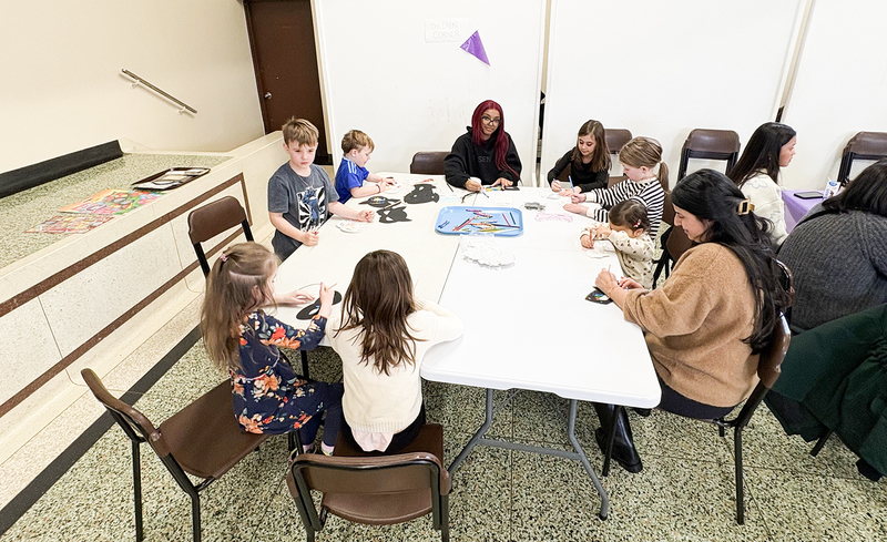 Photos of the event with children doing colouring activities