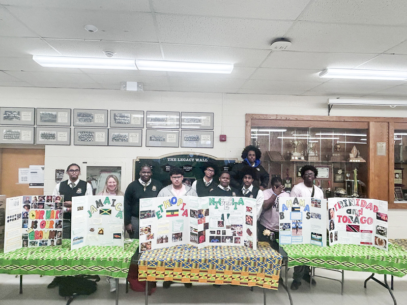 Photo of Chaminade students with their presentations