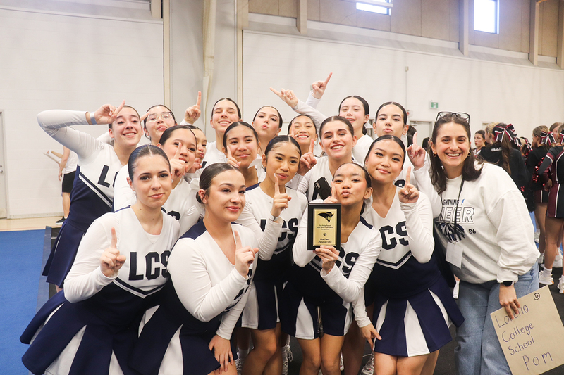 Group photo of the Loretto College cheer team with their award