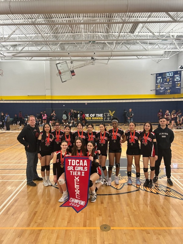 Volleyball team posing with champions 2026 banner