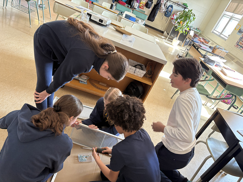 Photo of students in the program setting up the equipment for the plants