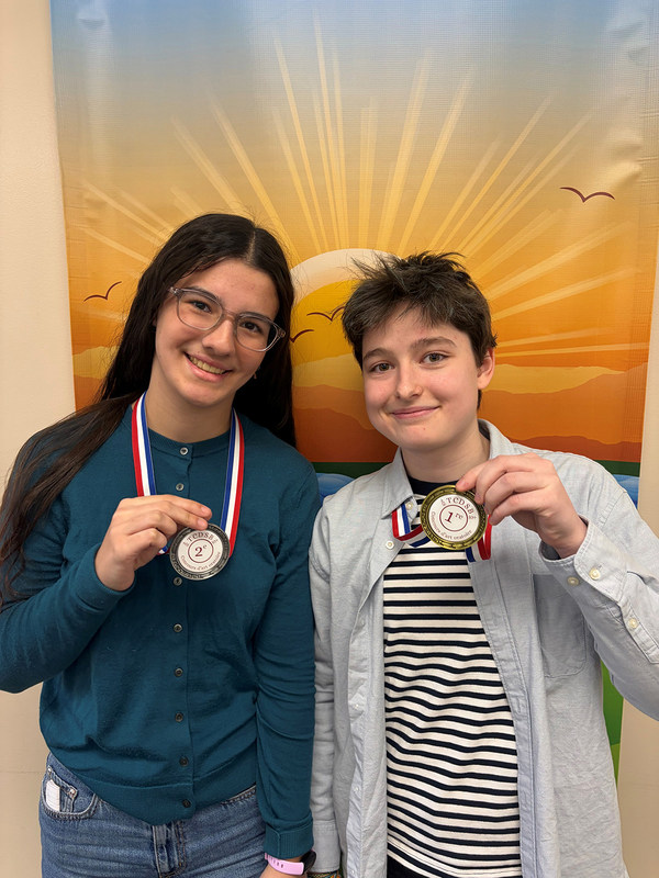 Photo of Olivia and Ash with their medals