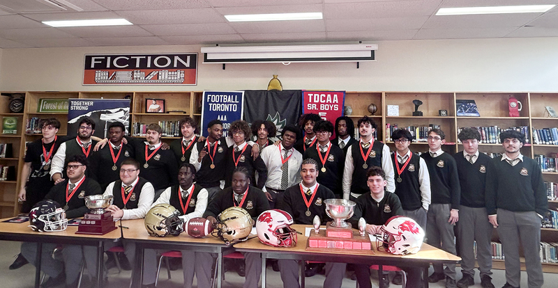 Photo of Chaminade students with their championship banners and award trophies