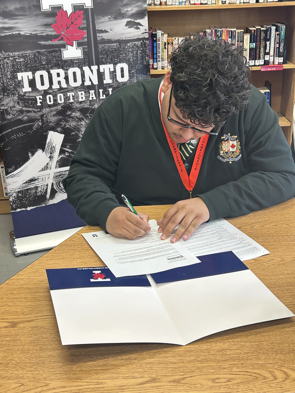 Photo of Chaminade student signing letter of intent