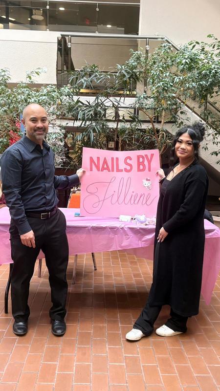 Photo of Jillian with Michael Consul holding up the poster advertising her business