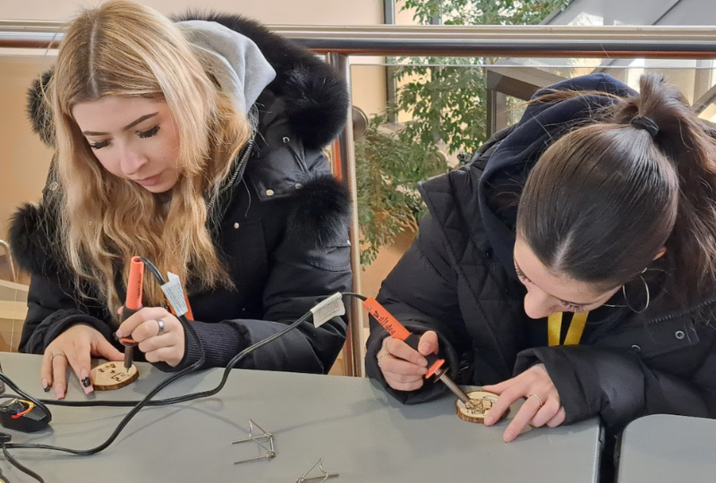 Photo of students trying woodburning
