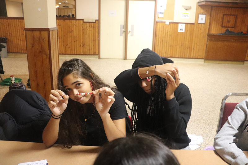 Photo of students making friendship bracelets at the retreat