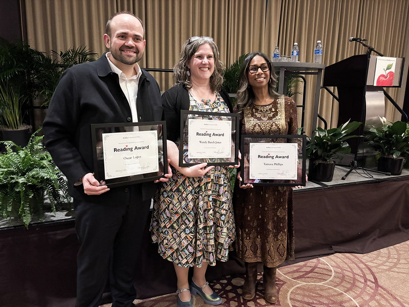 Photo of Oscar with his award along with two other recipients of the award