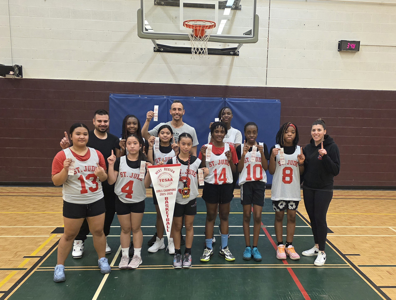 Group photo of the St. Jude girls basketball team with their championship awards