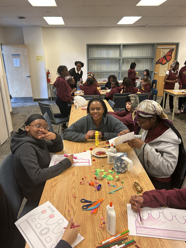 Photo of three students designing their crown decorations together