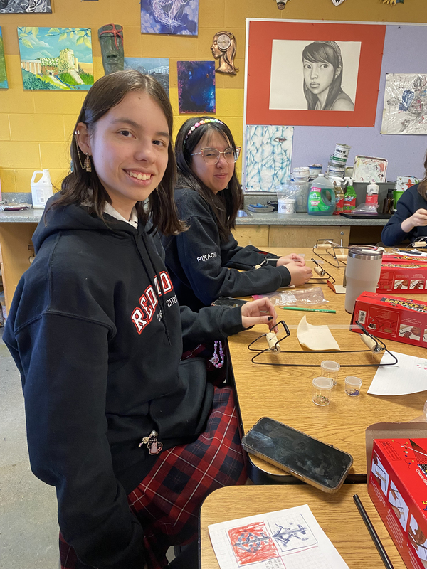 Photo of students working on their beading