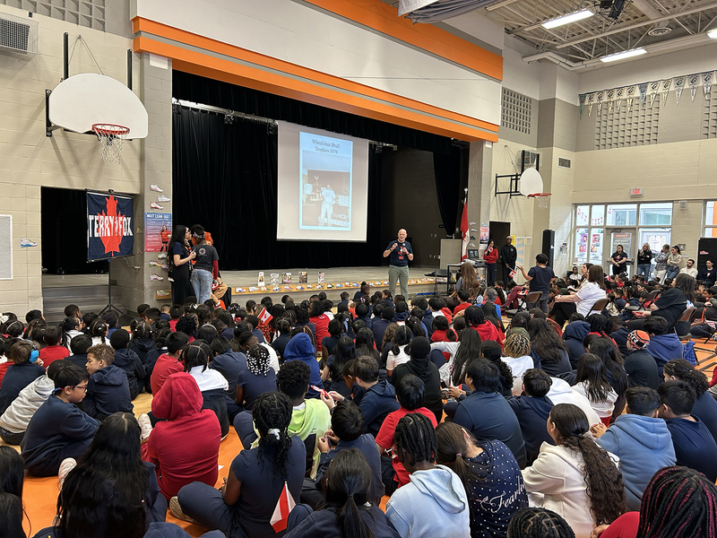 Photo of Fred Fox speaking to St. Andre students at the assembly