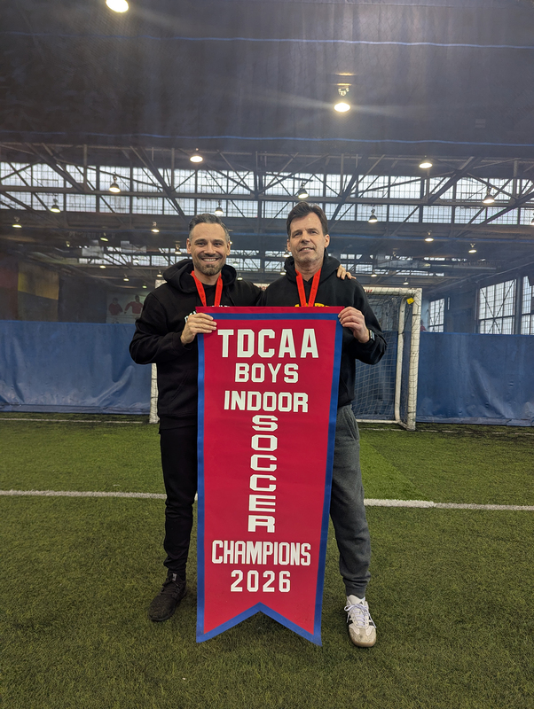 Photo of the Dante coaches with the championship banner