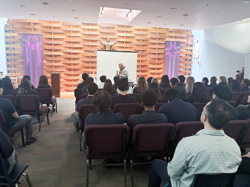 Photo of Father Ho Lung speaking to Senator O'Connor students and staff