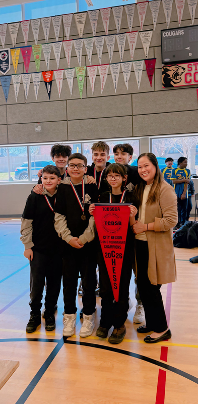 Photo of Precious Blood chess students with their medals and championship banner