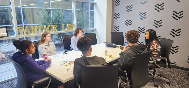 Photo of MPSJ students discussing together at Vantage Law