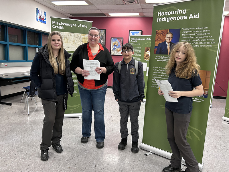 Group photo of Bishop Allen students and teacher with the exhibit