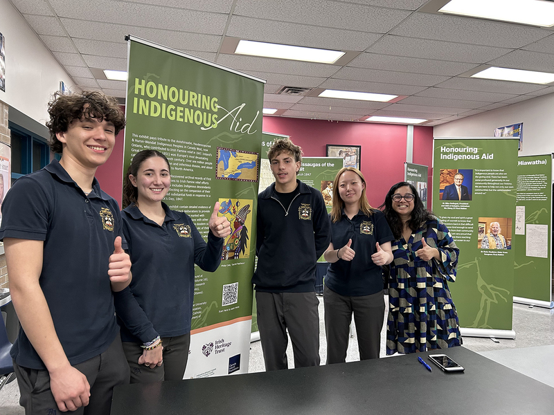 Group photo of Bishop Allen students and teacher with the exhibit