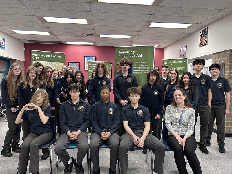 Group photo of Bishop Allen students and teacher with the exhibit