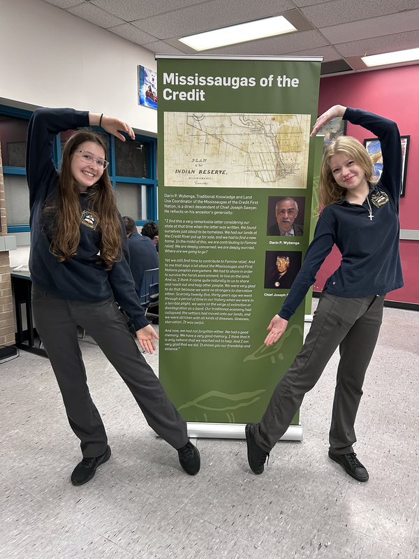 Group photo of Bishop Allen students with the exhibit