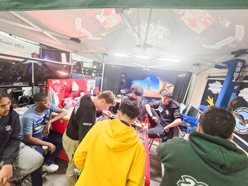 Photo of the Chaminade Robotics team with the machine that they built