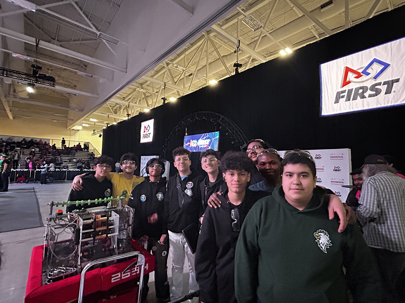 Photo of the Chaminade Robotics team with the machine that they built