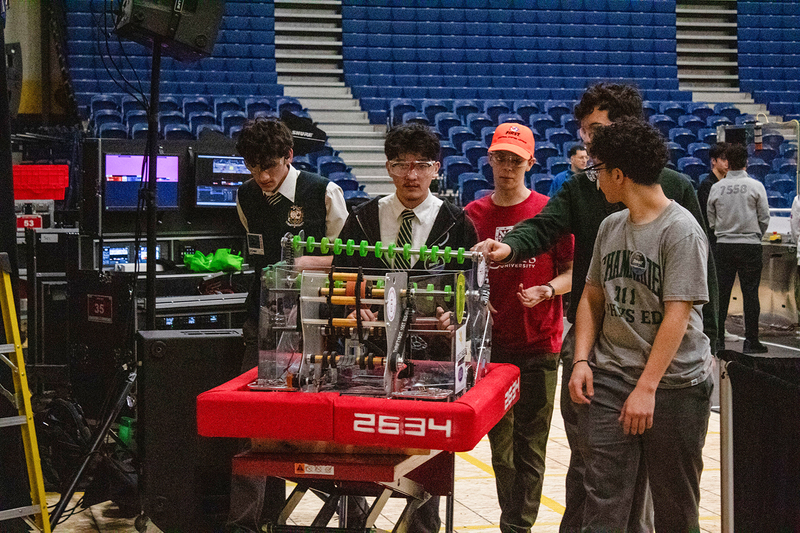 Photo of the Chaminade Robotics team with the machine that they built