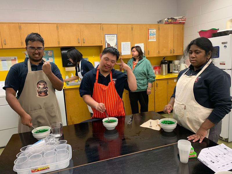 Photo of the ISP students creating the JELL-O along with their teachers