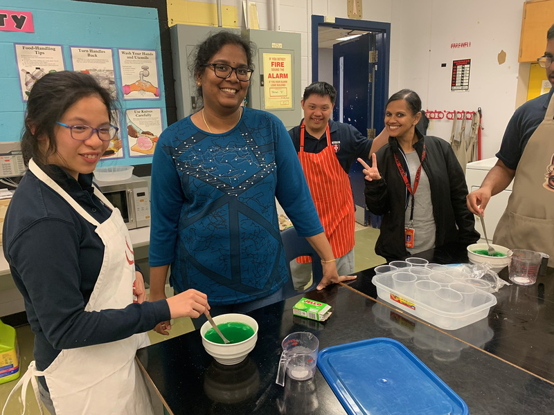 Photo of the ISP students creating the JELL-O along with their teachers
