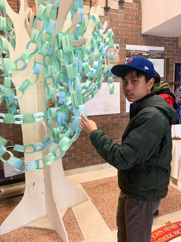 Photo of one of the students looking at the tree