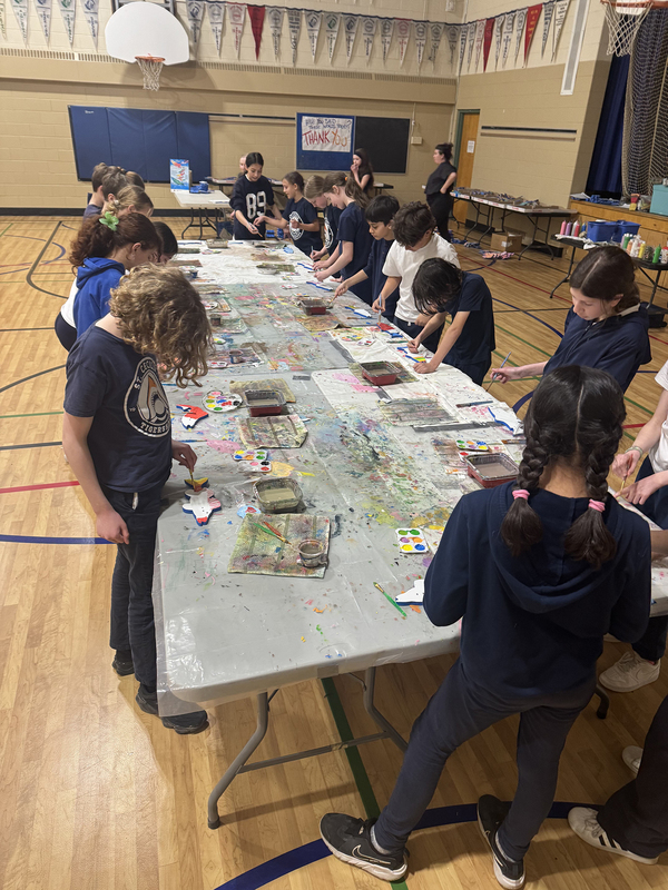 Photo of the students coloring the wooden fish