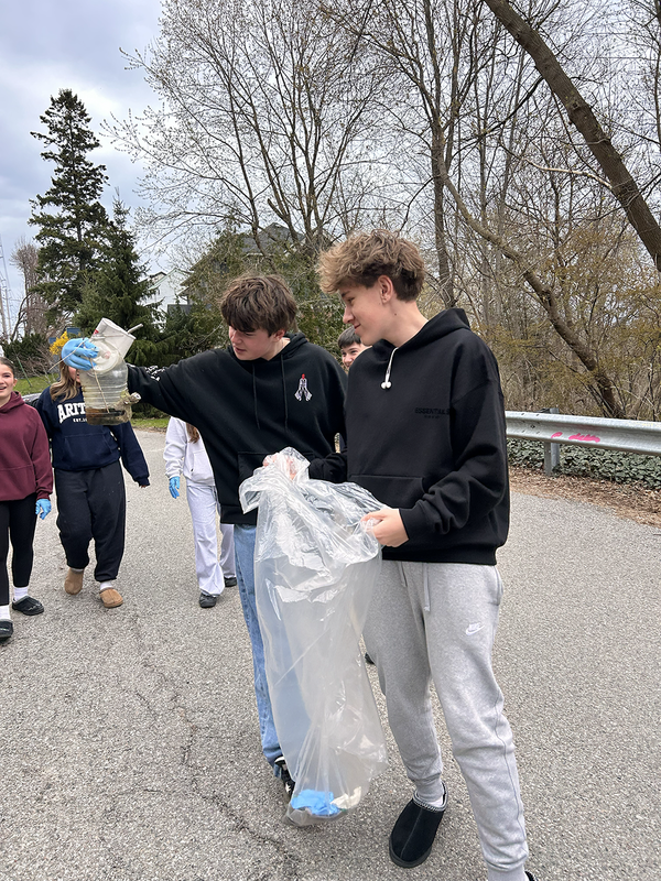 Photo of Bishop Allen students cleaning up the outdoors