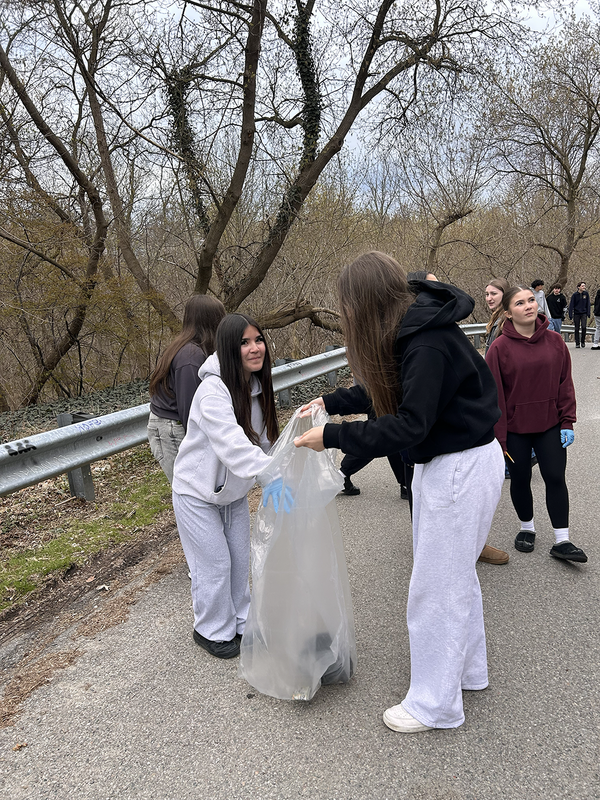 Photo of Bishop Allen students cleaning up the outdoors