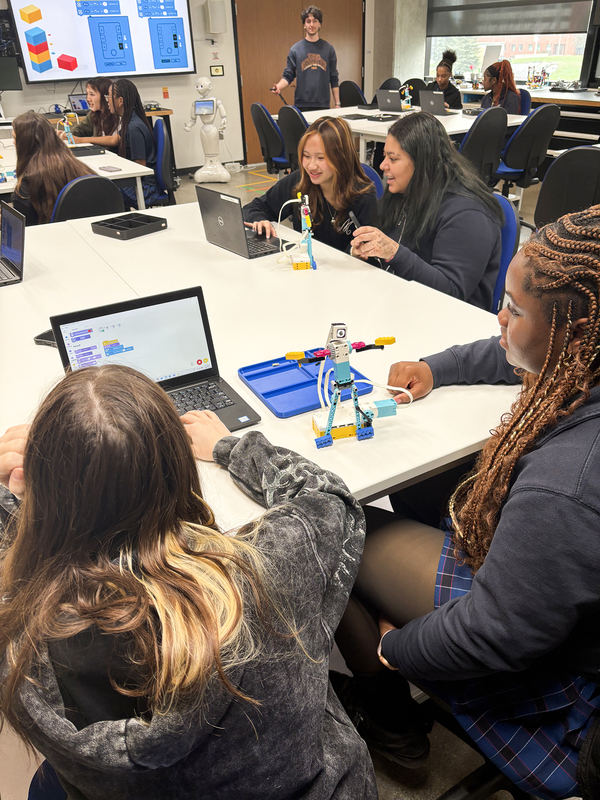 Photo of Madonna students working on coding their robots