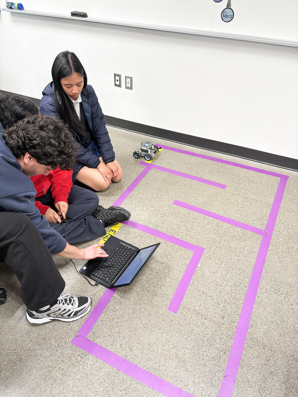 Photo of Madonna students working on coding their robots