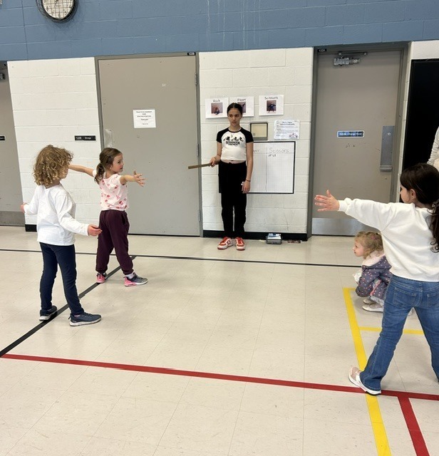 Photo of St. Ambrose students at Family Math Night with their props