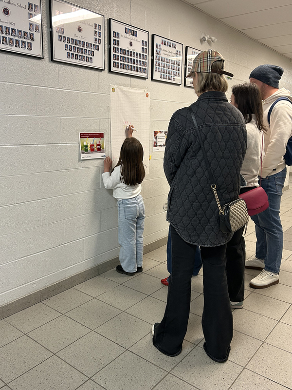 Photo of St. Ambrose students at Family Math Night with their props