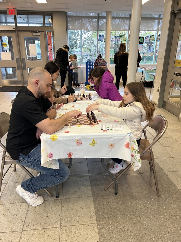 Photo of St. Ambrose students at Family Math Night with their props