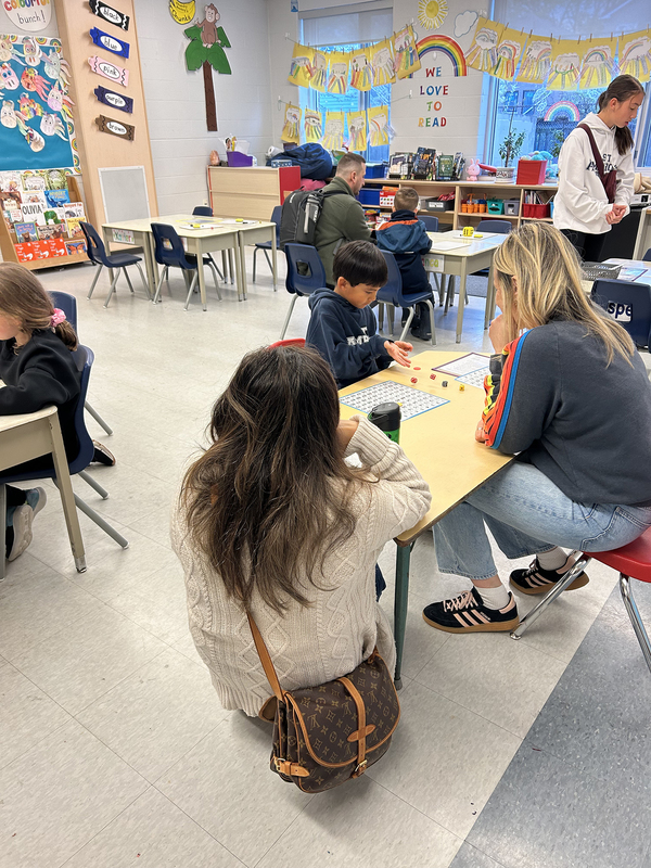 Photo of St. Ambrose students at Family Math Night with their props