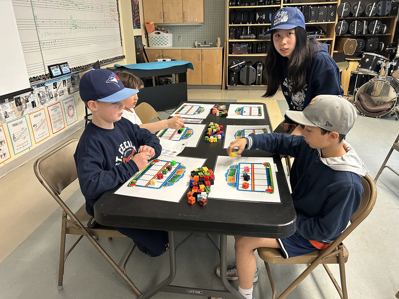 Photo of St. Cecilia students doing activities at Math Night