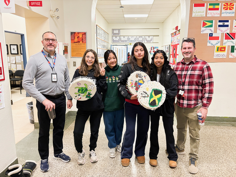 Photo of St. Theresa Shrine students posing with the drums they painted and TCDSB staff