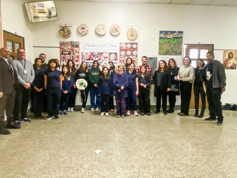 Photo of St. Theresa Shrine students posing with the drums they painted and TCDSB staff