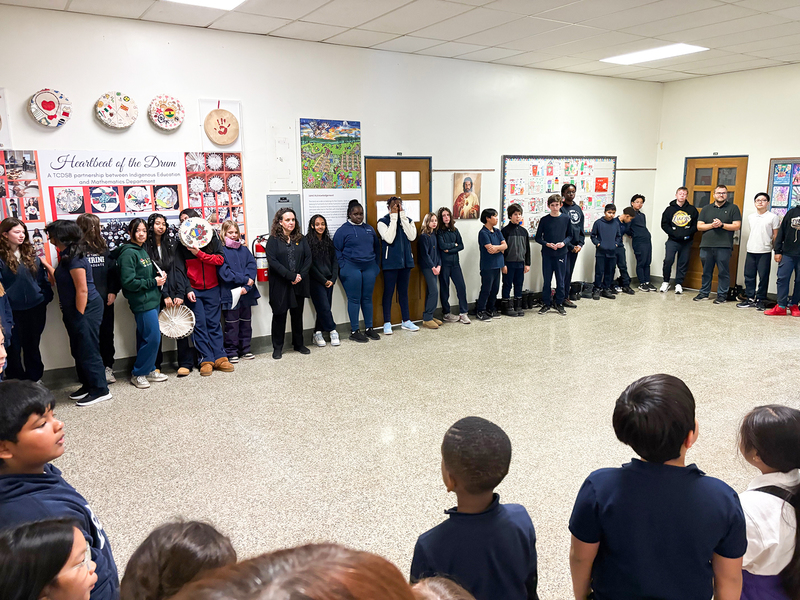 Photo of St. Theresa Shrine students posing with the drums they painted and TCDSB staff