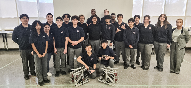 Photo of the OCS Robotics team students and staff with the robot they built