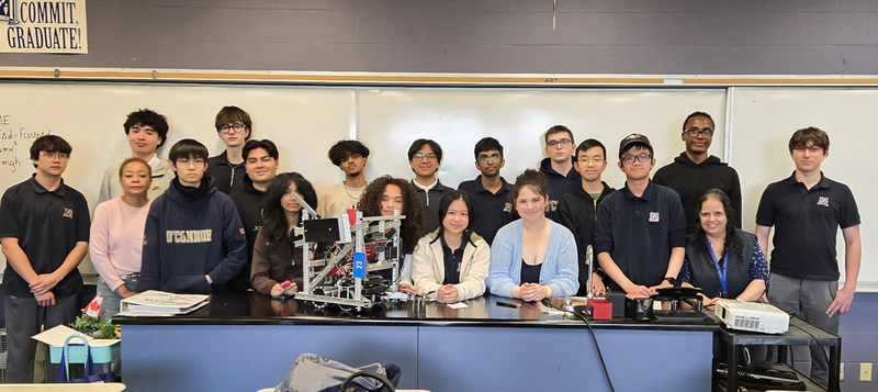 Photo of the OCS Robotics team students and staff with the robot they built