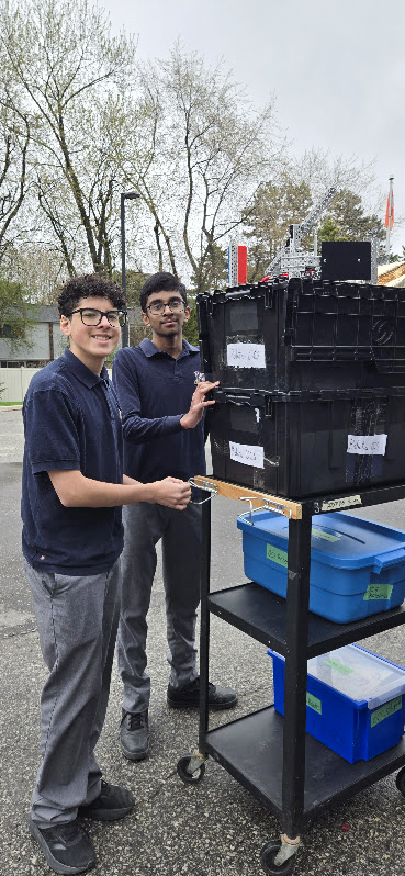 Photo of the OCS Robotics team students moving their equipment to the competition