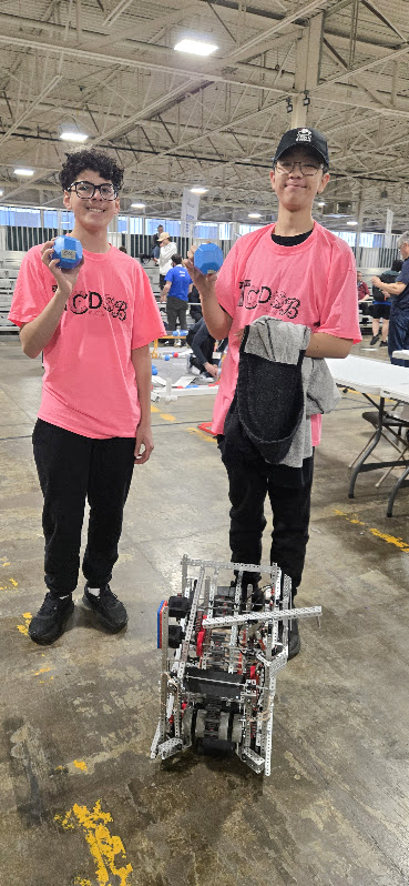 Photo of the OCS Robotics team students operating their robot during the competition