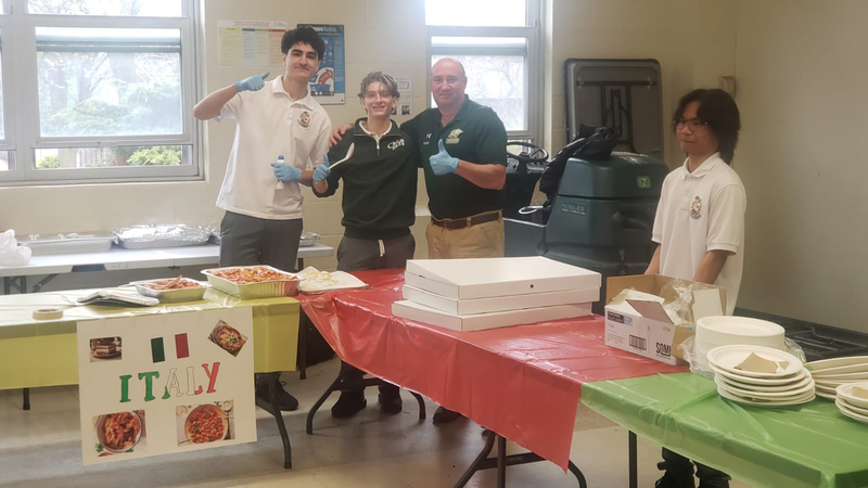 Photo of Chaminade students and staff serving food at the Italy cultural table