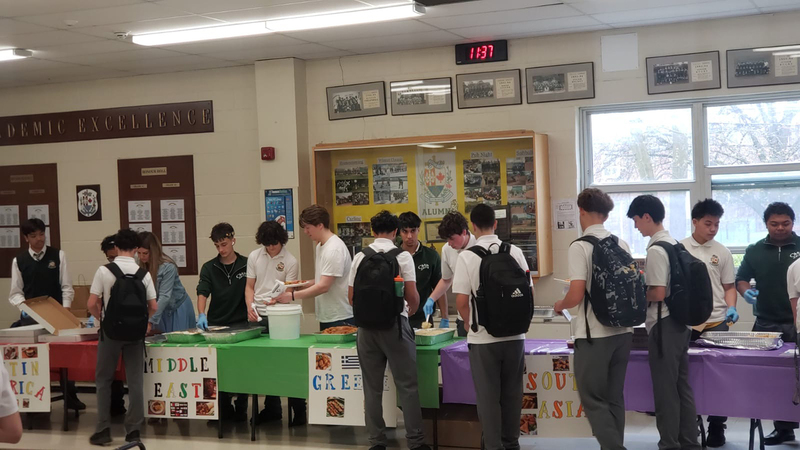 Photo of Chaminade students taking food from the various cultural tables
