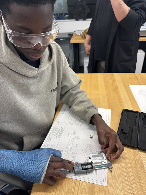 Photo of student working on Aviation math with special measuring tools during the event